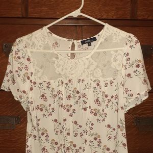 Medium short sleeved blouse with small flowers and lace across front.